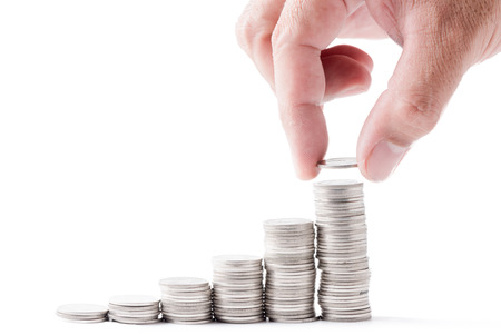 business man hand put coin to cion stacked isolated on white background, saving concept