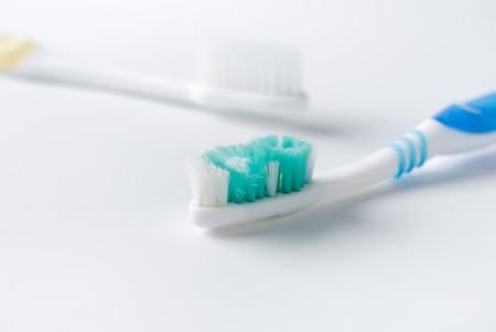 Used toothbrush and new toothbrush on white background, healthcare concept.