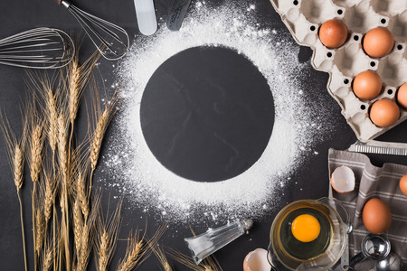 Baking utensils and ingredient with whisk egg on black background, Frame border design text space imagesの写真素材