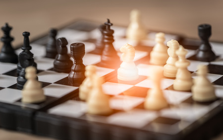 Small knight ,chess on board business concept.