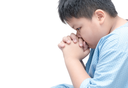 fat boy praying isolated over white background. asian boy hand praying, Hands folded in prayer concept for faith, spirituality and religionの写真素材