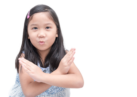 cute asian girl making stop gesture over white background, sign and symbol concept.の写真素材
