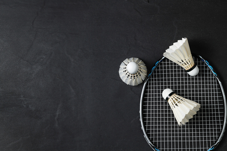 Shuttlecocks and badminton racket on black background.Sport concept, Concept winner, Copy space image for your text.の写真素材