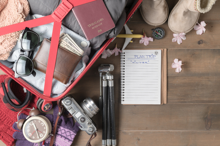 prepare winter trip and accessories travel items for on old wooden board, flat lay, top view background.の写真素材