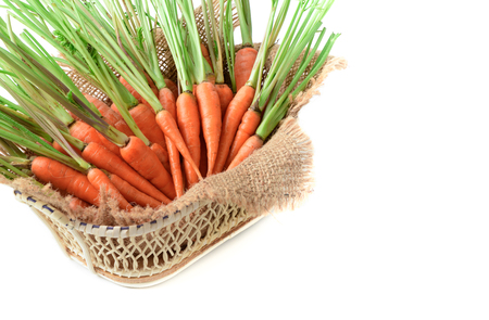 fresh carrot, baby carrot in basket isolated on white background, This vegetable is an exceptionally rich source of carotenes and vitamin-A.の写真素材