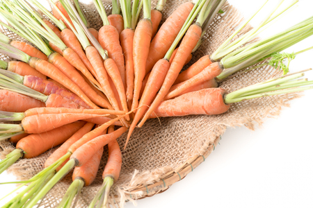 fresh carrot, baby carrot in basket isolated on white background, This vegetable is an exceptionally rich source of carotenes and vitamin-A.の写真素材
