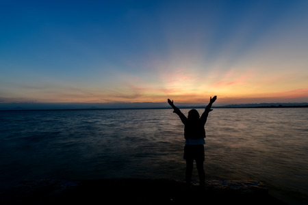 first sunrise of year 2018 with back side freedom and happiness woman at dam on morning.