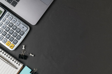 Office black stone desk table with calculator, laptop and pen,  business background concept and copy space..の写真素材