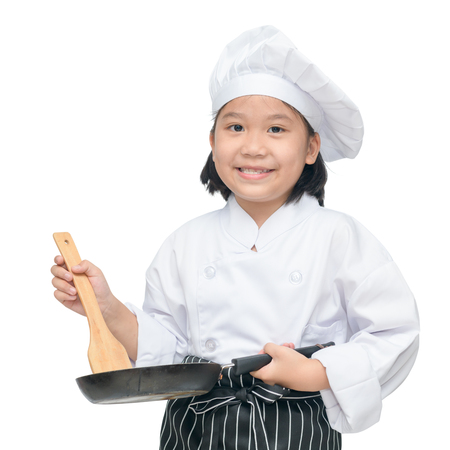 Happy asian girl chef holding cooking utensils and smile isolated on white backgroundの写真素材