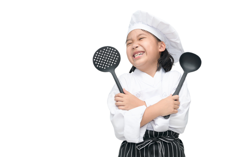 Happy asian girl chef holding cooking utensils and smile isolated on white backgroundの写真素材