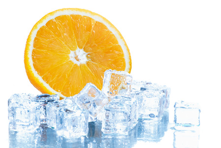 sliced fresh orange in ice cube  isolated in white background.の写真素材