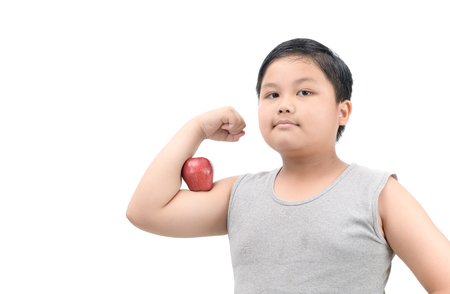Handsome obese fat boy show muscle with apple isolated on white background, diet and healthy concept.の写真素材