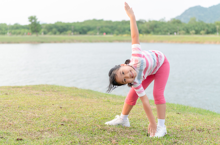 Happy girl exercise at health park on evening, healthy and  leisure concept.の写真素材