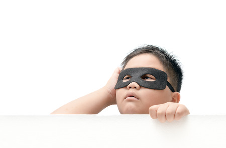 masked child appeared from below with an expression of surprise isolated on white background..の写真素材