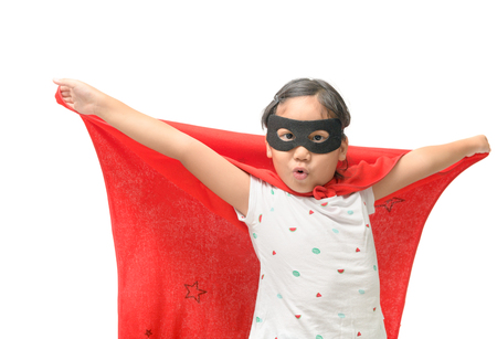 Little child plays superhero isolated on white background, Girl power concept.の写真素材