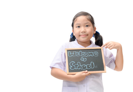 cute asian student showing welcome to school chalkboard isolated on white background, back to school concept.の写真素材
