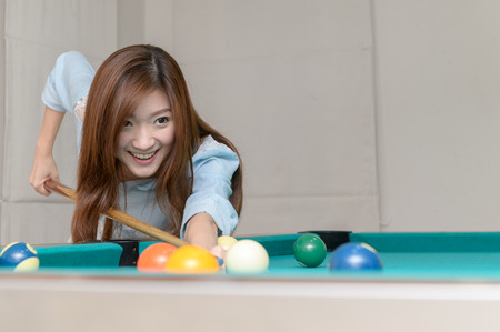 Asian pretty woman playing billards, sport and recreation concept..