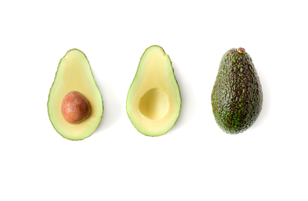 Fresh avocado. Whole avocado fruit and two halves in a row isolated on white background, top view..
