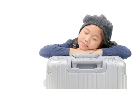 asian girl sleep on baggage wait plane or Ready to go on vacation, isolated on white background.の写真素材
