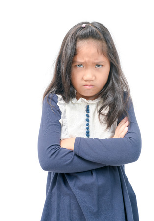 Angry little asian girl with blue dress isolated on white background, sign and gesture concept..の写真素材
