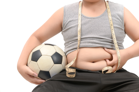 Obese fat boy holding football isolated over white, diet to lose weight and healthy concept.の写真素材