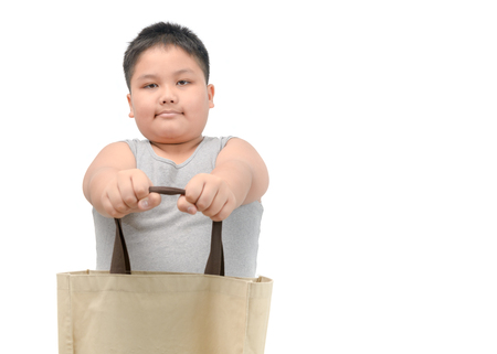 fat boy giving canvas tote bag isolated on white background, save environmental and recycle concept.の写真素材