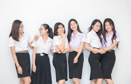 Happy young students standing together on whiteの写真素材