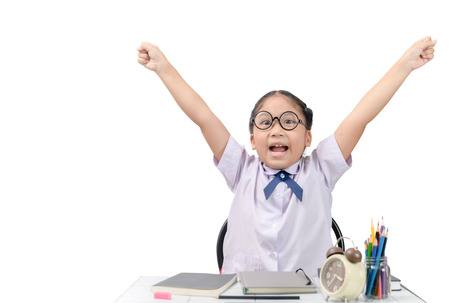 Little student happy after finished homework isolated on whiteの写真素材