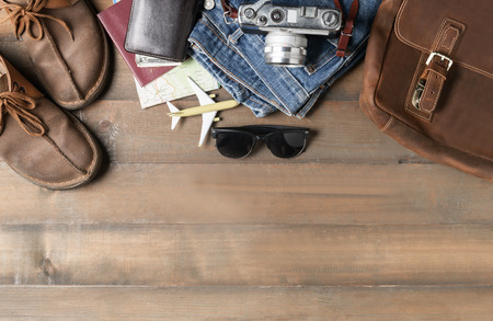 prepare backpack accessories and travel items on wood background with copy space, flat lay, top view backgroundの写真素材