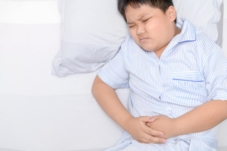 asian fat child suffering from stomachache or diarrhea. healthy concept.の写真素材