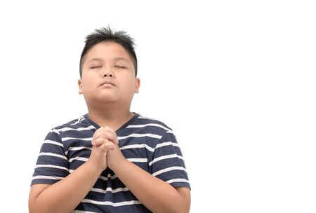 Asian boy praying isolated on whiteの写真素材