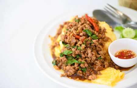 Fried basil with pork on an omelette and Fish sauce with chilli, street food and popular thai food