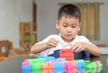 Cute little boy is playing wood brick, toy and learning concept.の写真素材