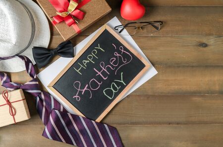 Happy Father's day on blackboard with accessories dad on woodの写真素材