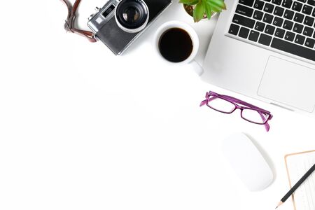 White office desk table with laptop computer and vintage camera, cup of coffee and glasses. Top view with copy space, flat lay..の写真素材