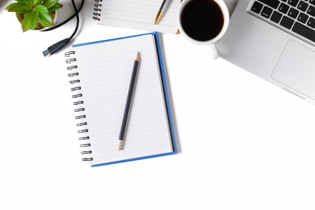 White office desk table Blank notebook with laptop computer, cup of coffee isolated on white background. Top view with copy space, flat lay..の写真素材