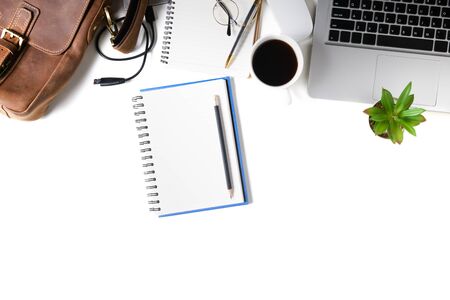 White office desk table Blank notebook with laptop computer, cup of coffee isolated on whiteの写真素材