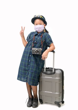 Child traveler wear surgical mask with suitcase isolated on whiteの写真素材