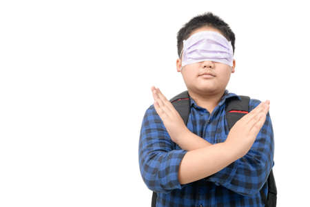 Wrong way to wear surgical mask, Schoolboy wearing a surgical mask in the wrong way isolated on white background, prevent covid-19 infection conceptの写真素材