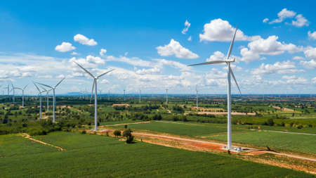 Aerial Landscape of windmills farm with white sky on blue sky at Huai Bong, Dan Khun Thot district,...