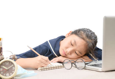 School girl learning online education classes feeling bored and write on notebook isolated on white background, Due to the outbreak of COVID 19 and education  conceptの写真素材