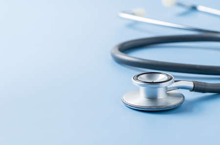 Old medical stethoscope on blue background. Health care concept.の写真素材