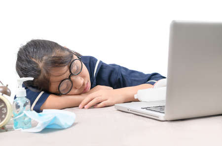 Tried student fell asleep while doing homework with the laptop isolated on white background,...
