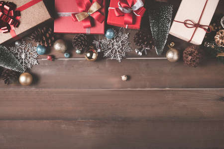 christmas background with decorations and gift boxes on wood background. Xmas and Happy New Year composition. Flat lay, top viewの写真素材