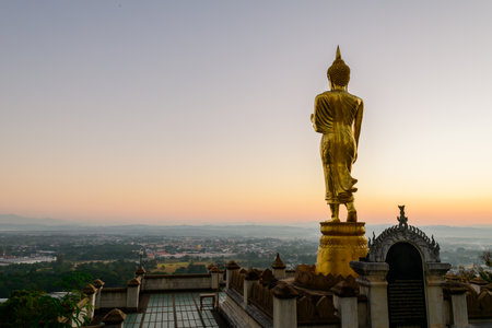 Big golden buddha statue standing in Wat Phra That Kao Noi on morning at Nan province Thailand,の写真素材