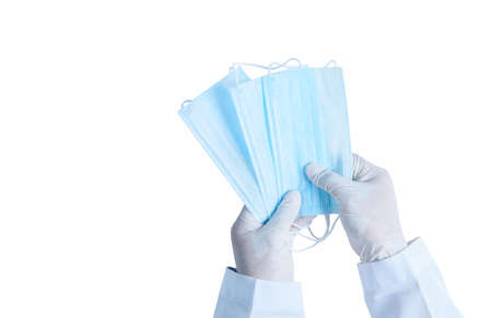 Doctor hands in medical gloves holding surgical  protective mask isolated on white background....