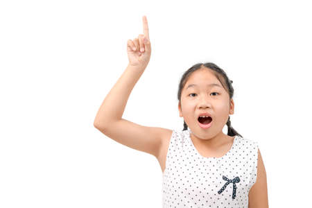 Cute  girl shocked and pointing her finger upwards isolated on  white background, copy spaceの写真素材