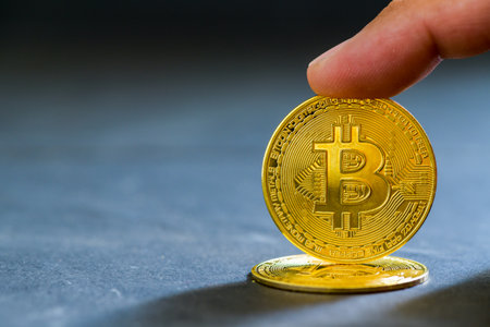 finger touch on bit coin on black background, electronic virtual money for web banking and...