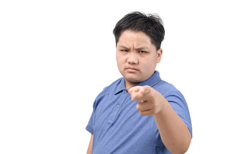 Angry obese boy point finger to camera isolated on white background, face emotion conceptの写真素材