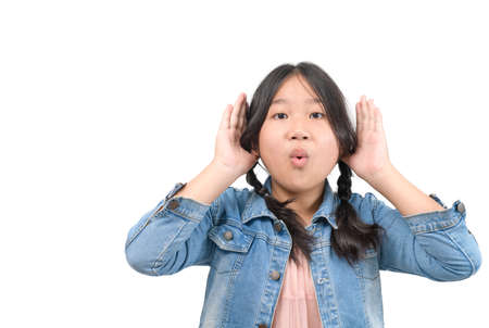 gesture and emotion concept - cute girl having hearing problem listening to something isolated on white backgroundの写真素材